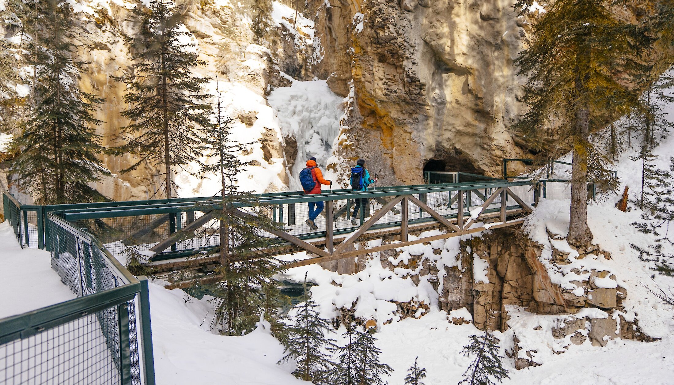 A couple winter hiking at Johnston Canyon in Banff