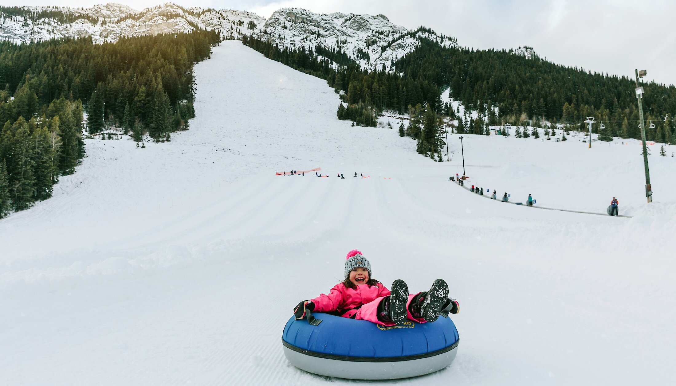 A young child snow tubing at mount norquay