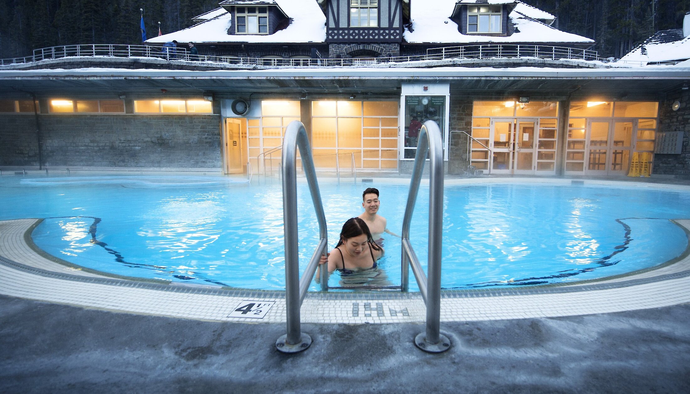 A couple bathing at the Banff upper hot springs