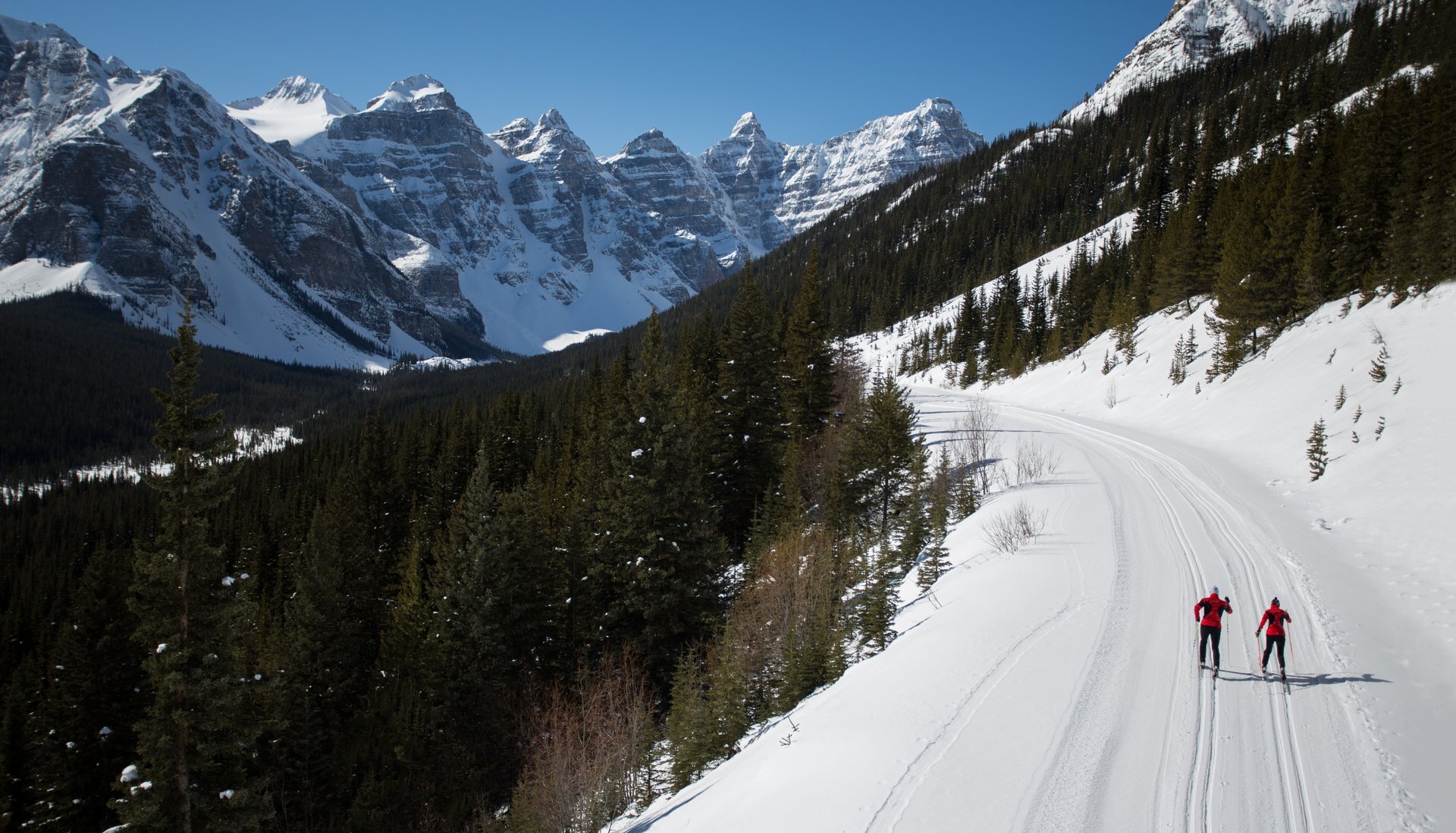 Two people cross country skiing the Moraine Lake Road in Banff National Park