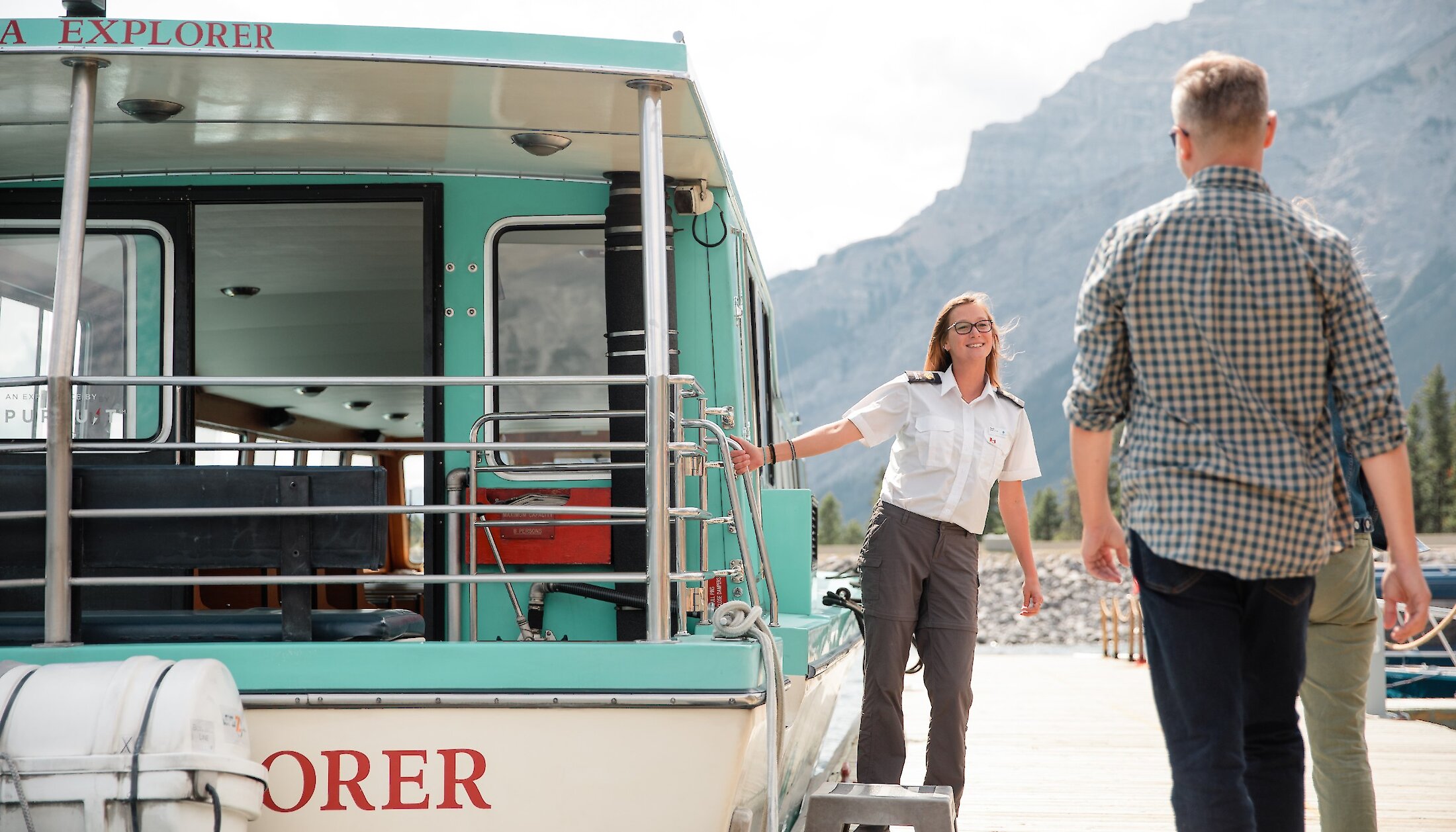 Boat captain welcoming guests on a lake Minnewanka Boat Cruise