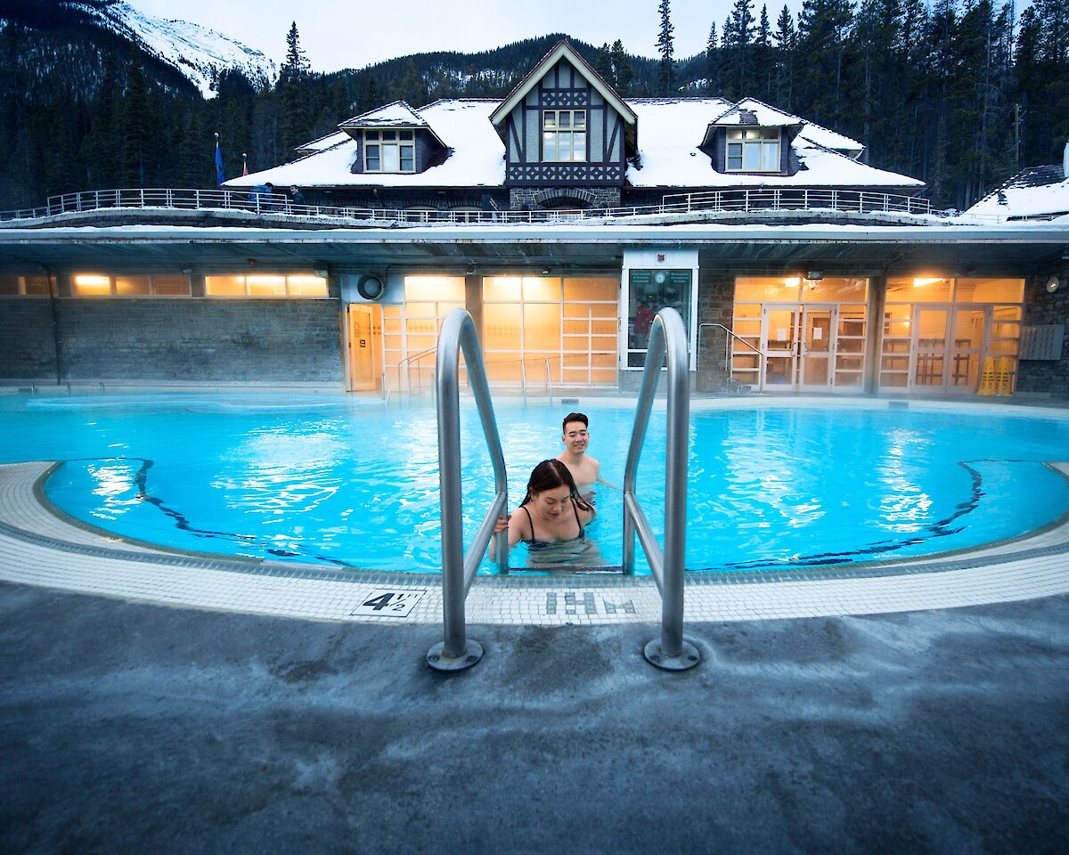 A couple soaking in the Banff Upper Hot springs