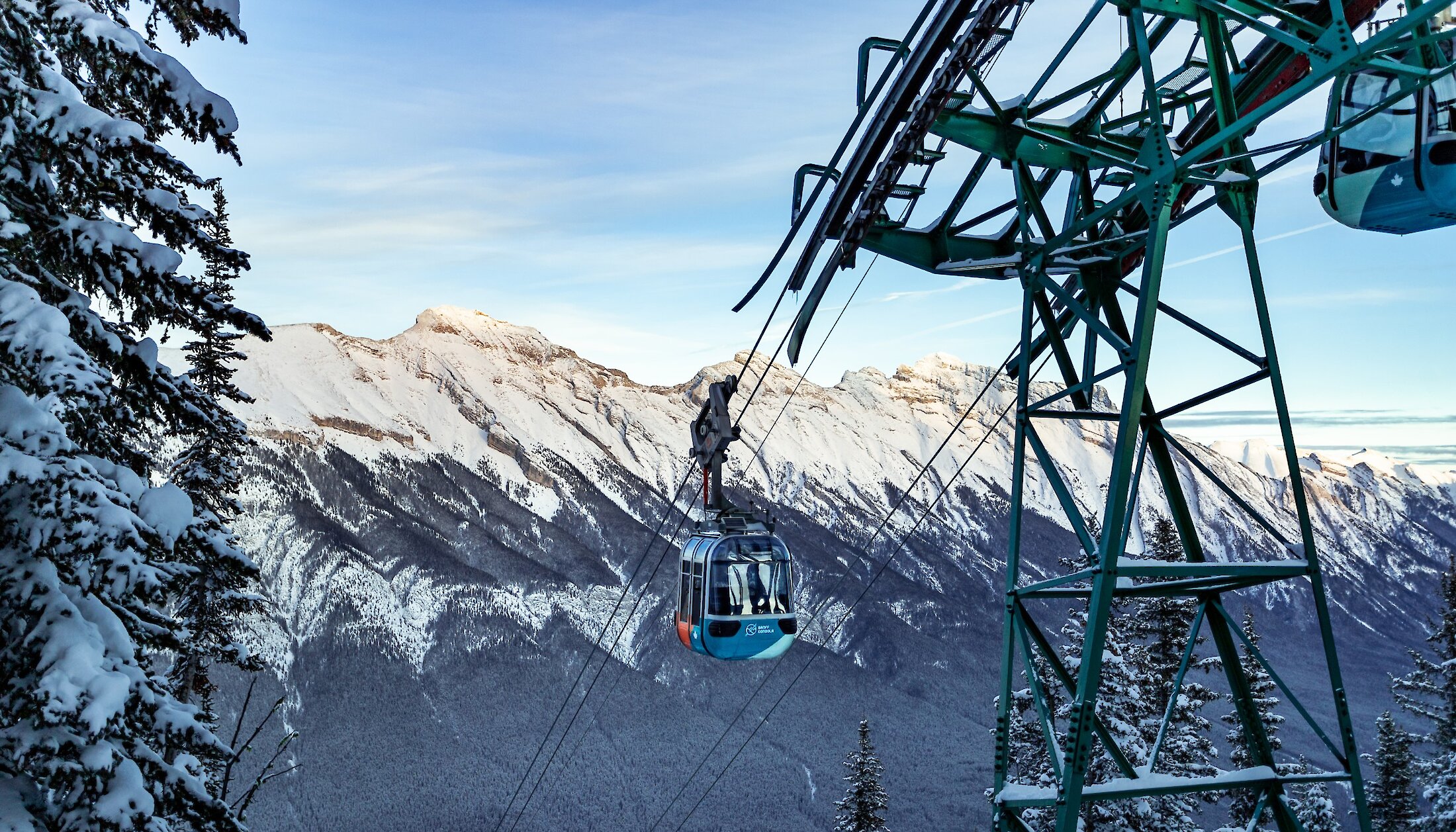 A Banff Gondola car with view of Mount Rundle in Banff