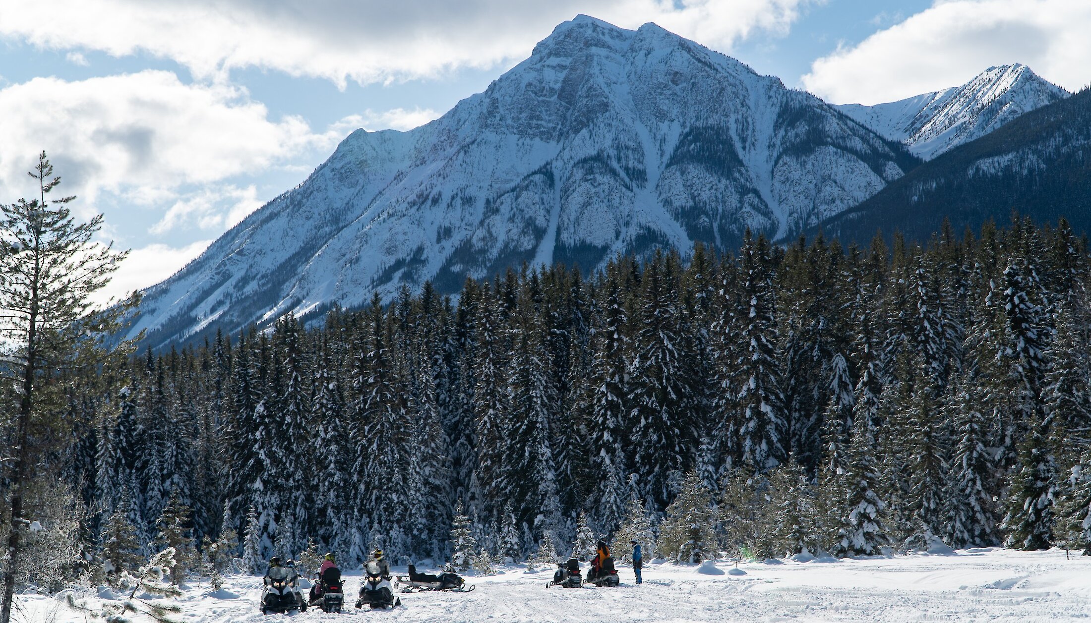Snowmobilers admiring the view on the snowmobile trail in Golden