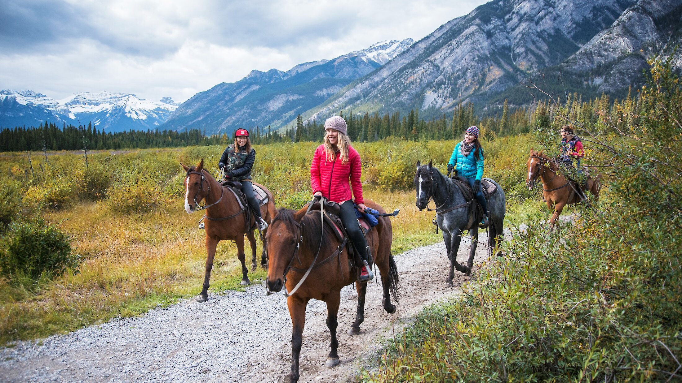 A group of friends horseback riding in Banff