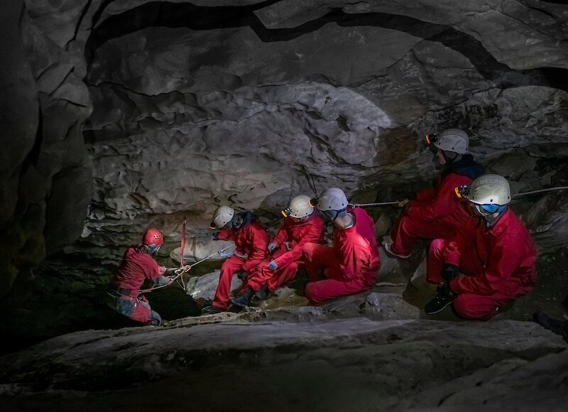 A group of people on a cave tour