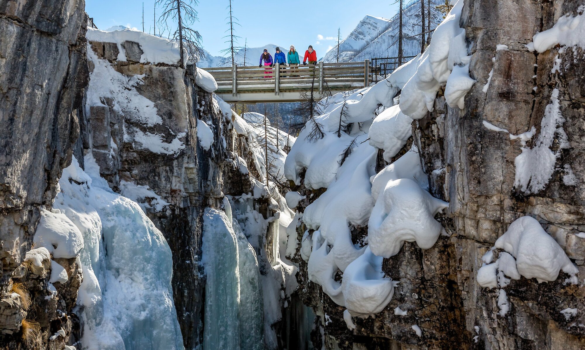 People on a bridge overlooking the Marble canyon in the winter