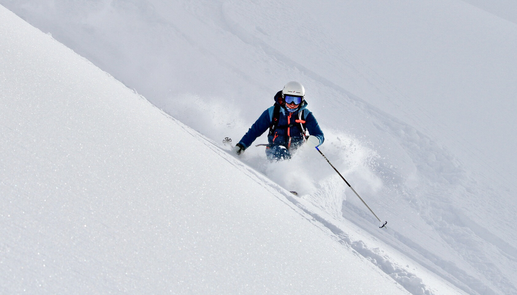 A skier enjoying the fresh powder and turns