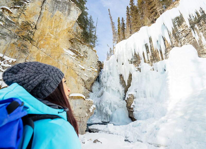 lady gazing at the ice falls in Johnston Canyon