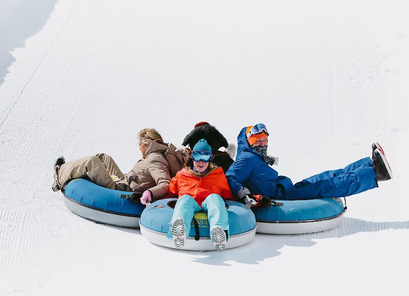 A family snow tubing at Mount Norquay
