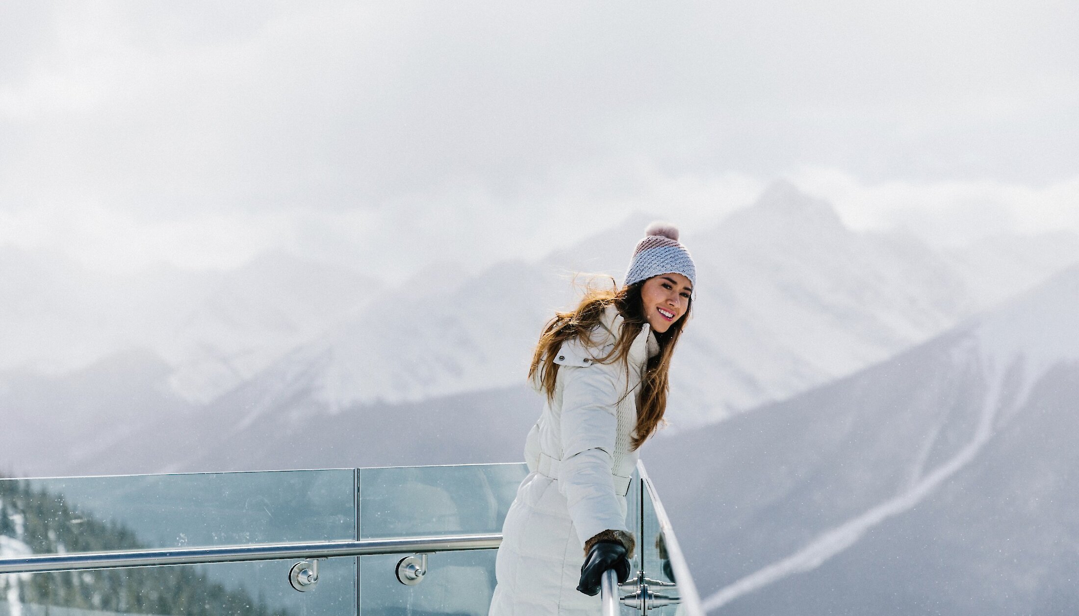 lady admiring the view from the top of the Banff Gondola in winter