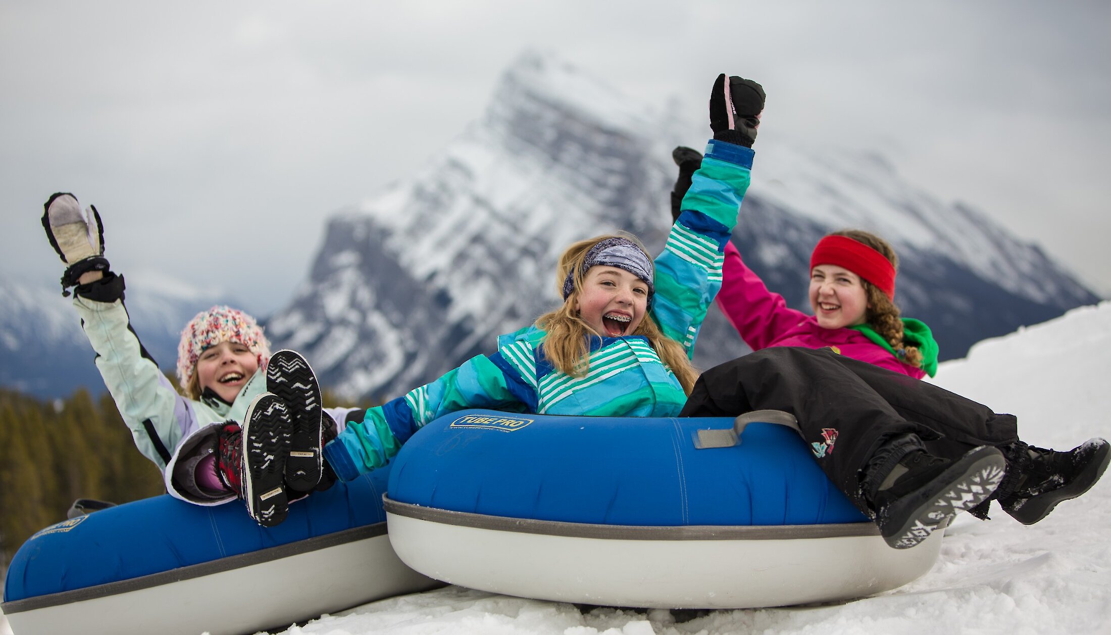 Kids enjoying snow tubing at Mount Norquay