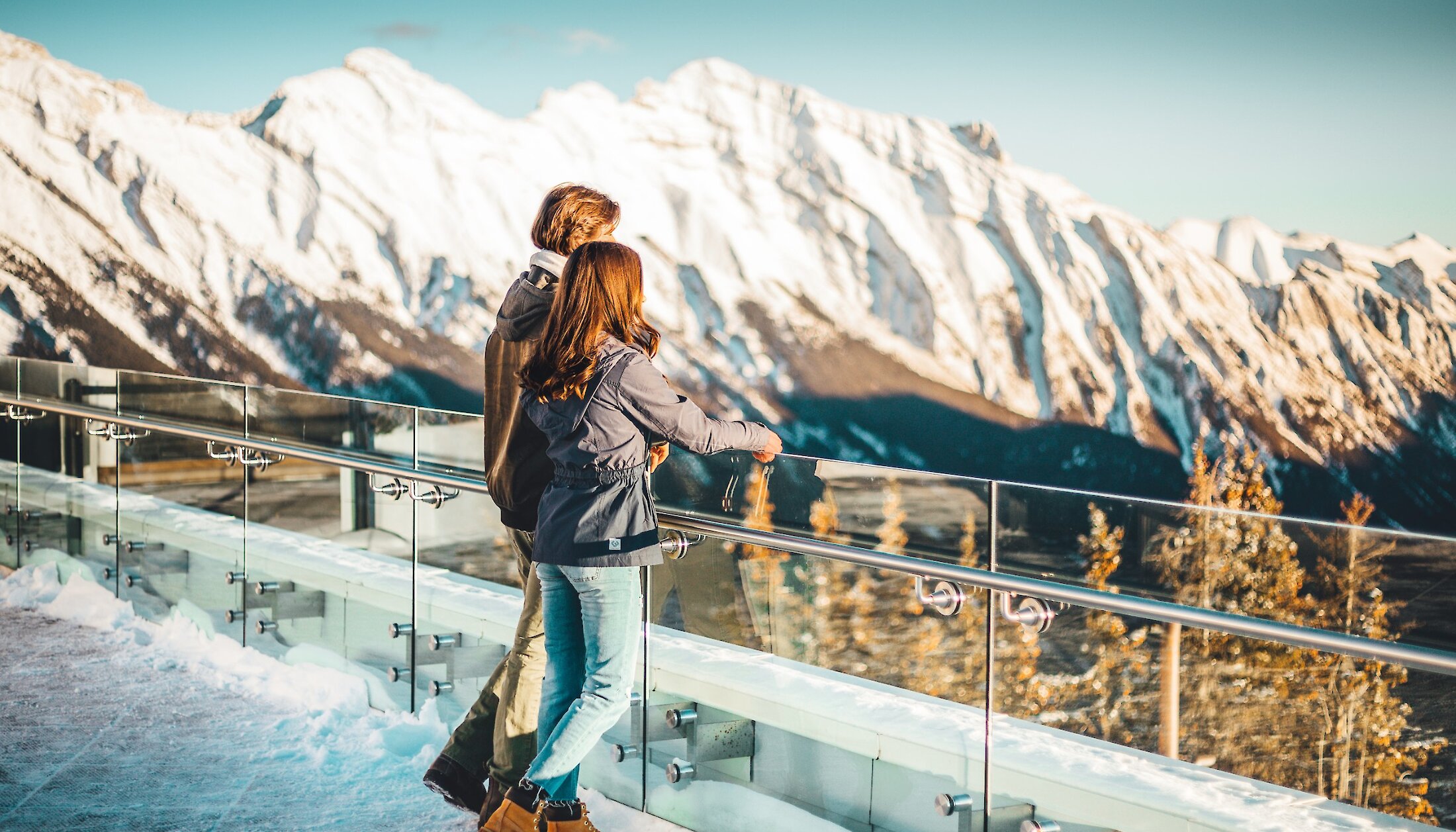 Couple admiring the views from the top of the Banff Gondola in winter