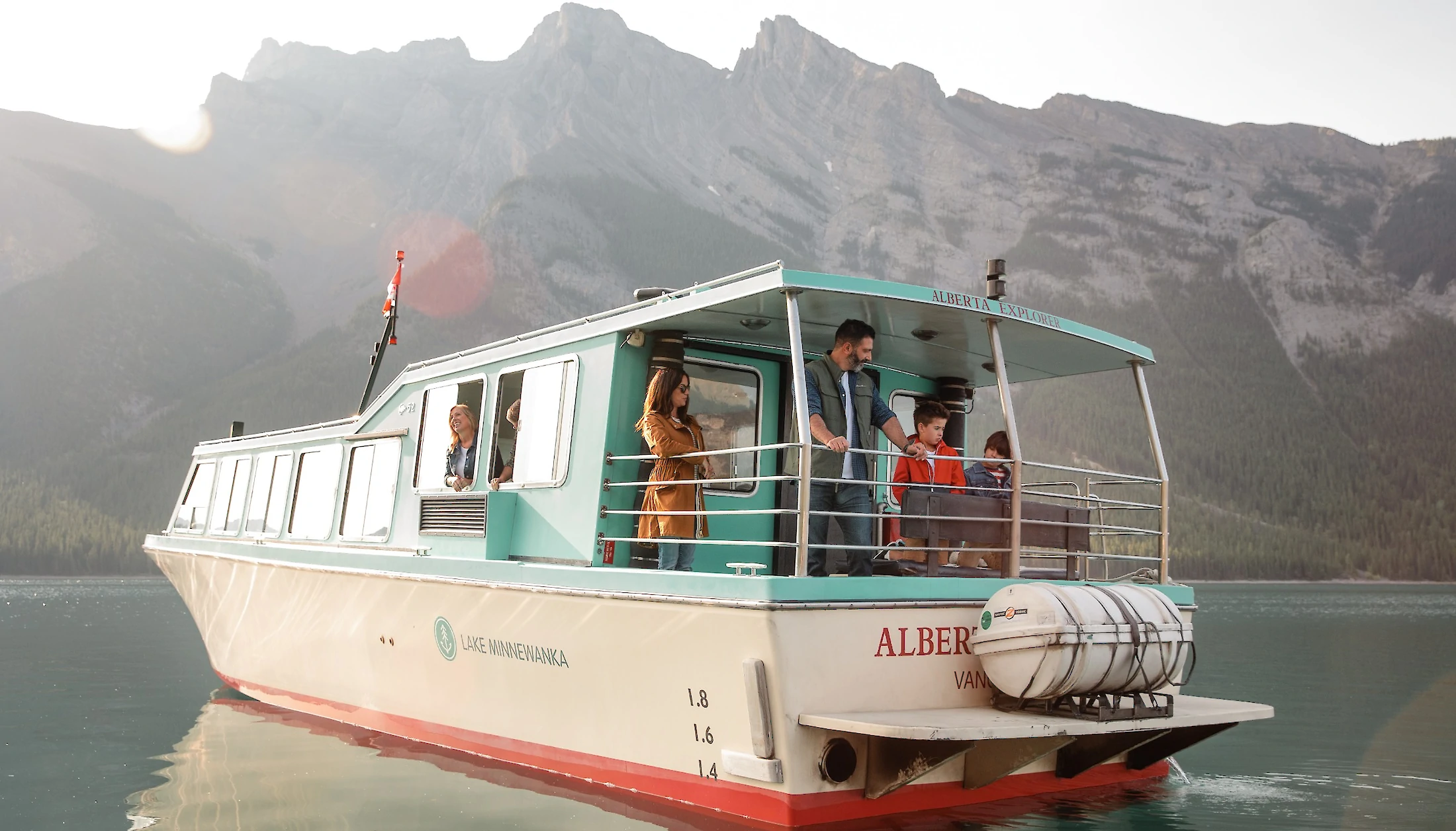 People enjoying a boat cruise on Lake Minnewanka