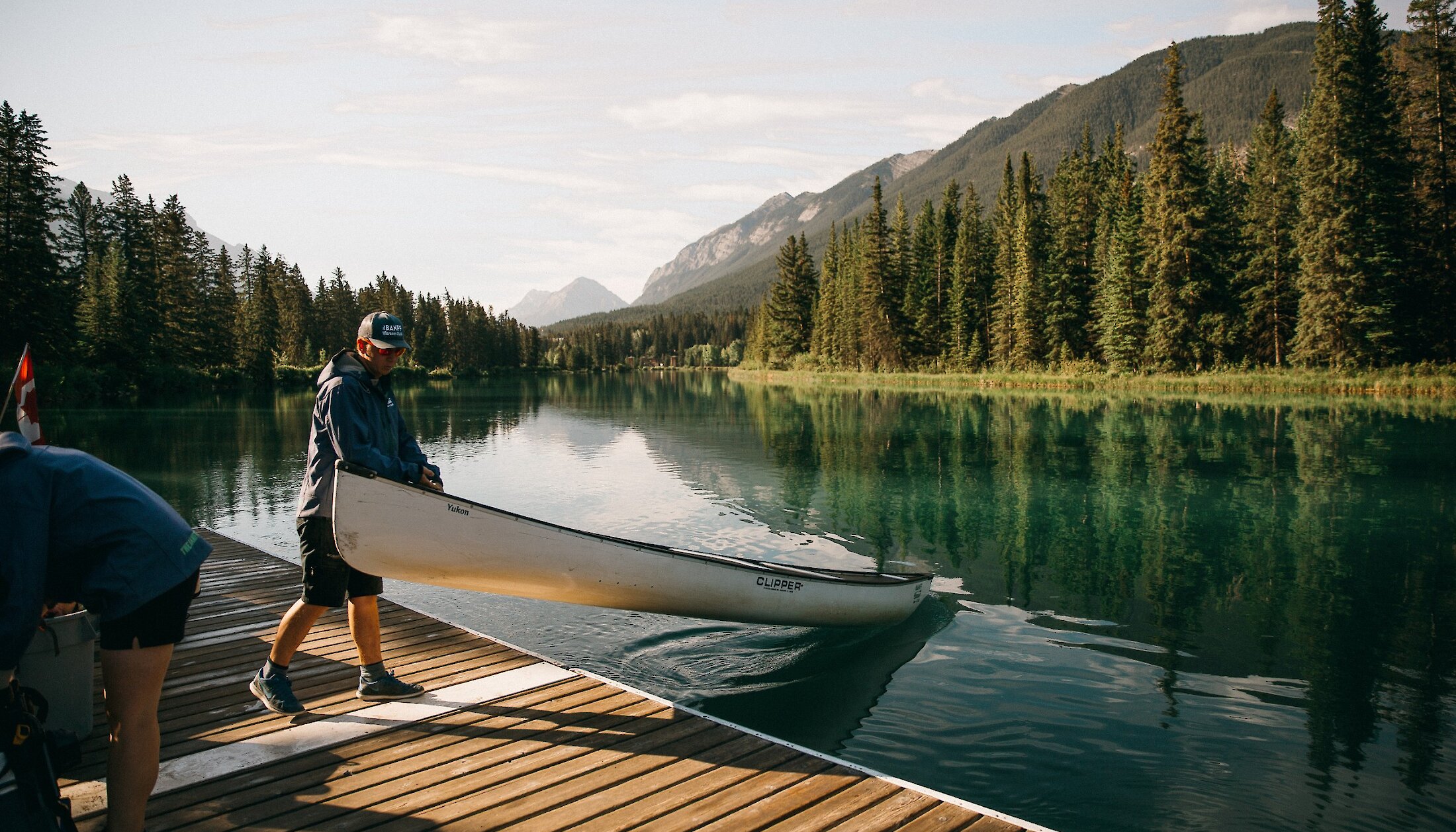 Loading the canoes into the Bow River at the Banff Canoe Club