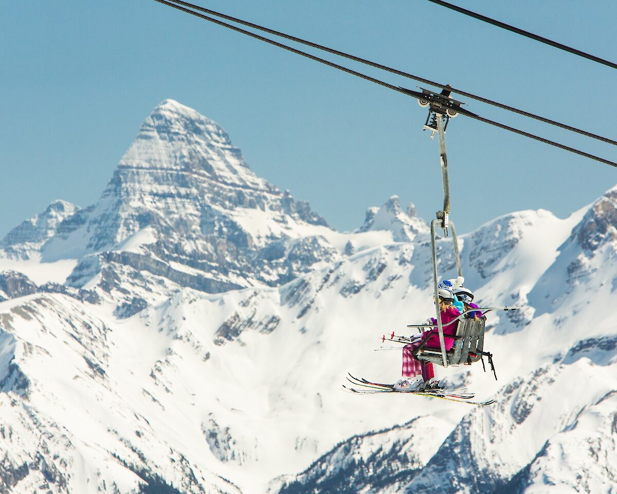 Skiers on a chairlift at Sunshine Village Ski Resort