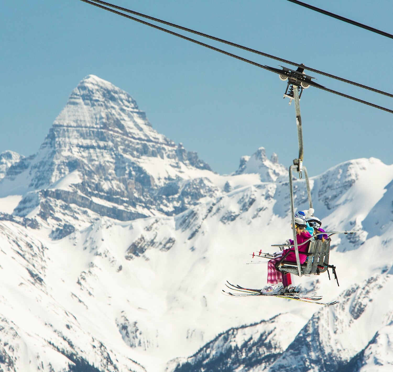 Skiers on a chairlift at Sunshine Village Ski Resort