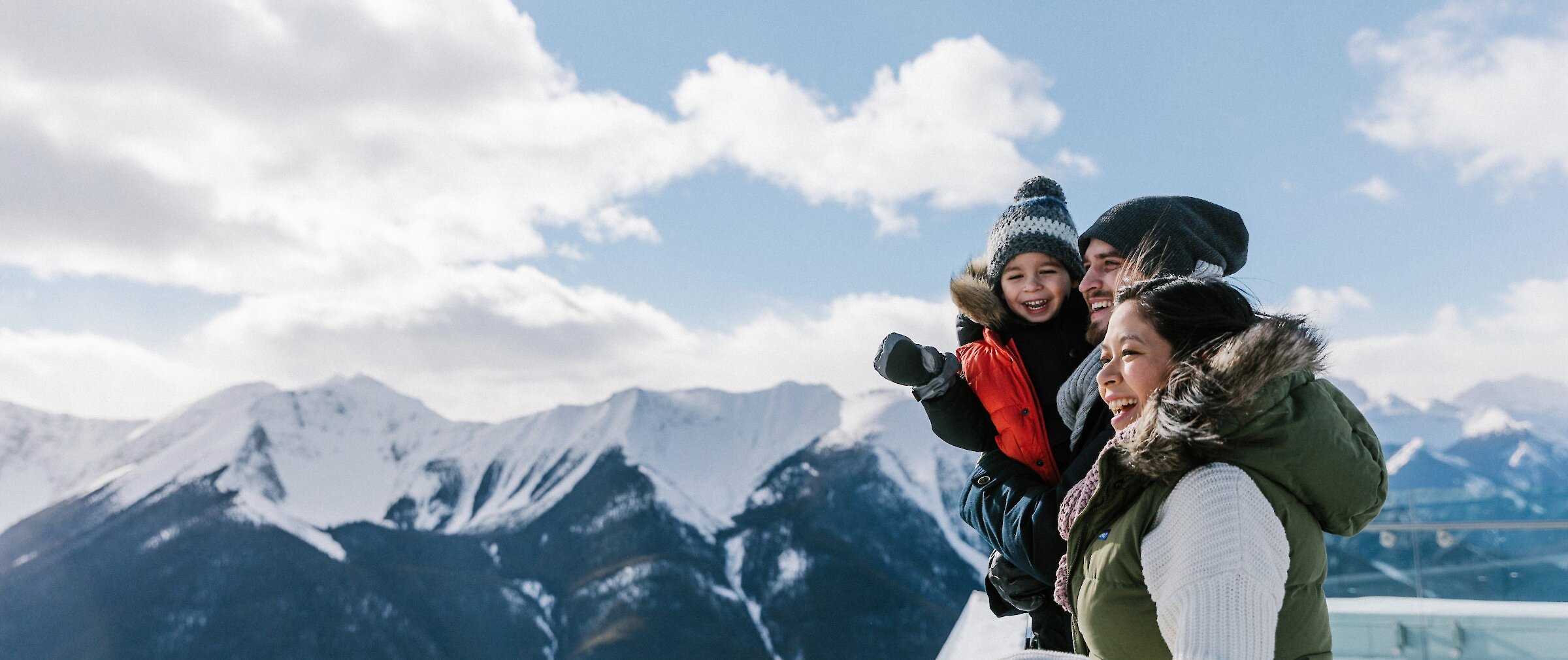 A family enjoying the views from the top of the Banff Gondola in winter