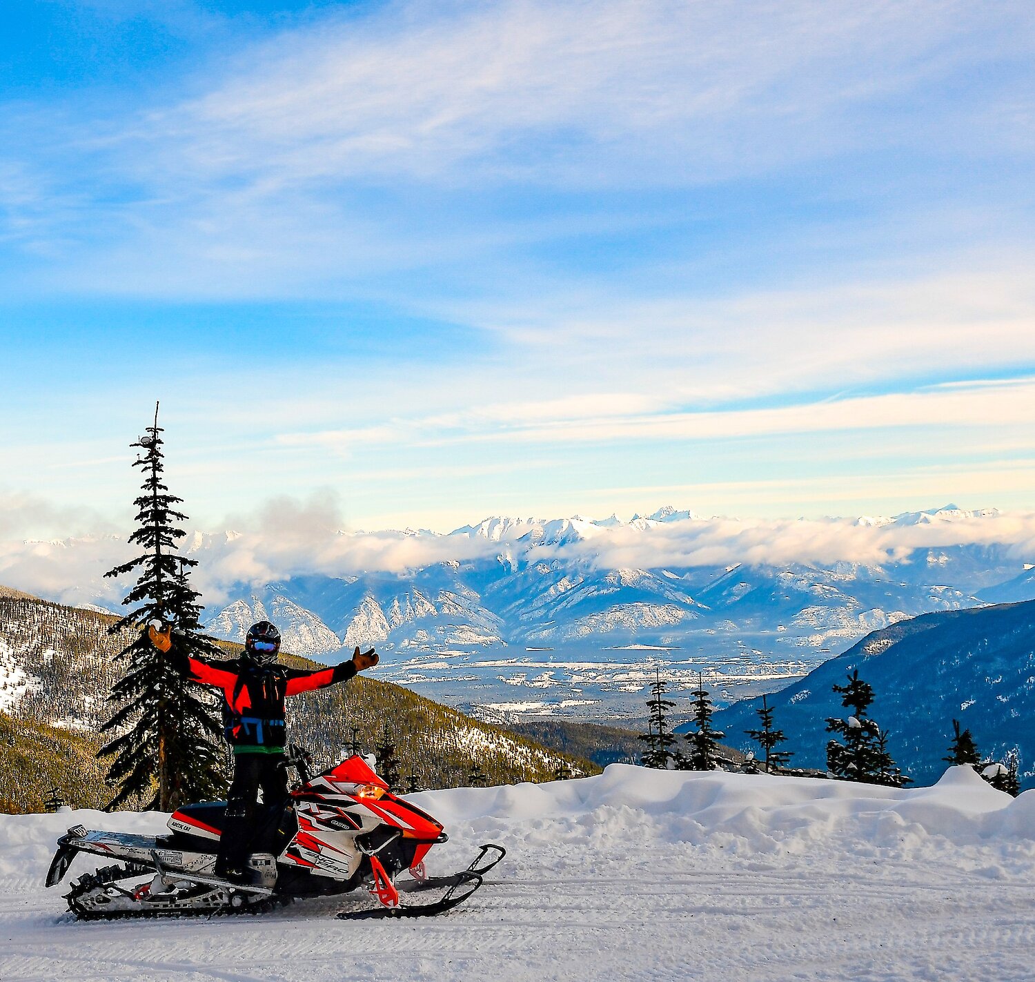 Snowmobile enjoying the views on a stop during Paradise Basin snowmobile tour