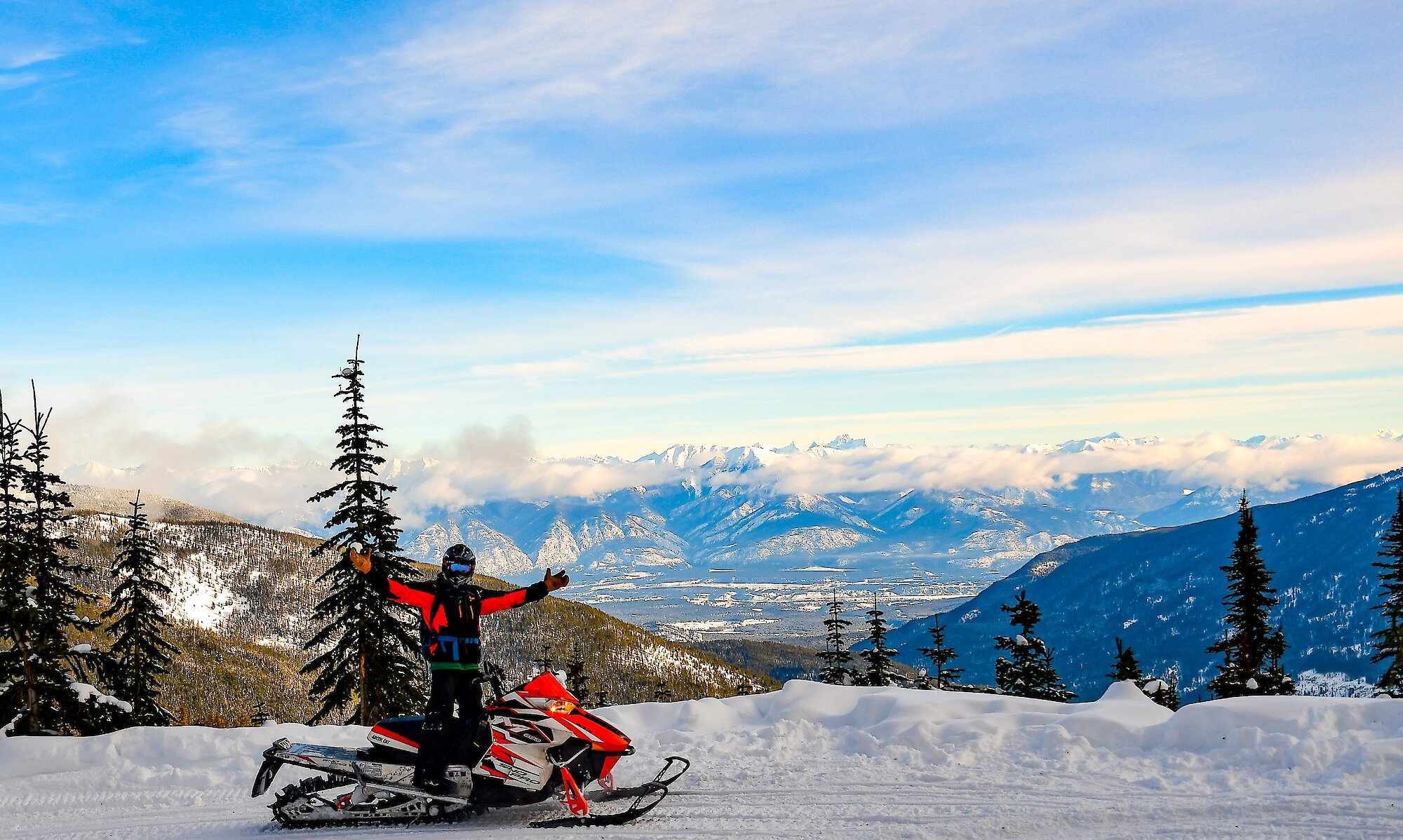 Snowmobile enjoying the views on a stop during Paradise Basin snowmobile tour