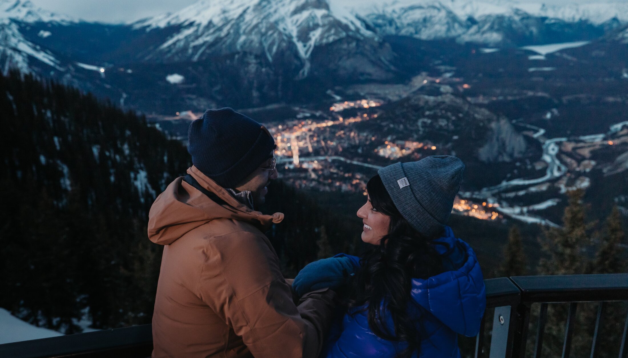 A couple enjoying the views of Banff Town at the Banff Gondola in winter