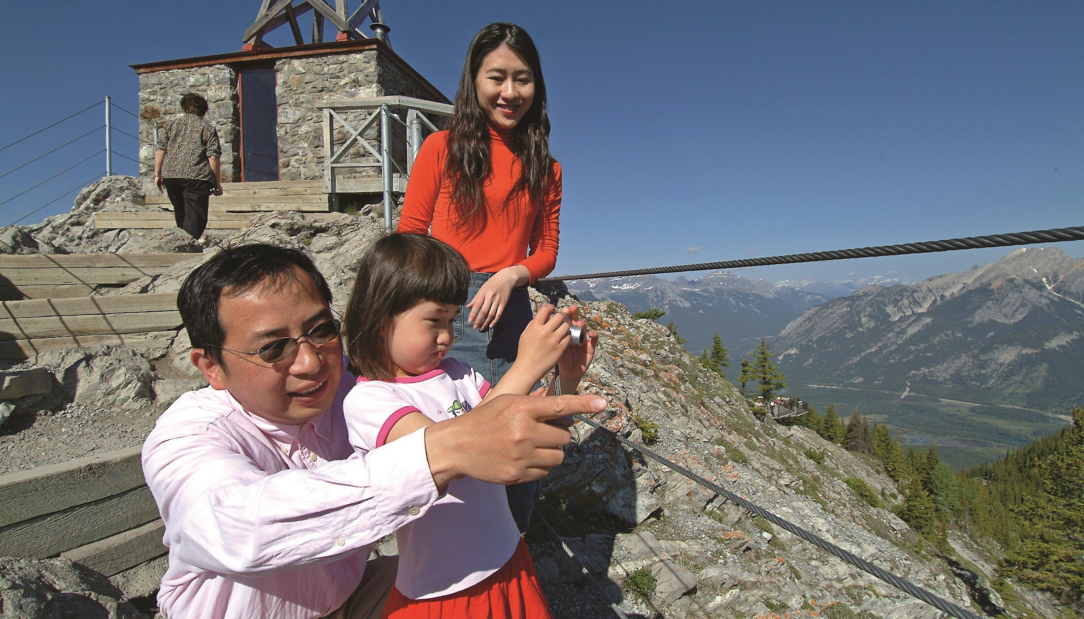 A family taking a photo at the Cosmic Ray Station at the Banff Gondola