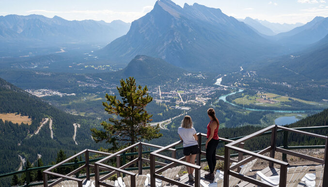 Two friends on the Mount Norquay viewing deck taking in the mountain views