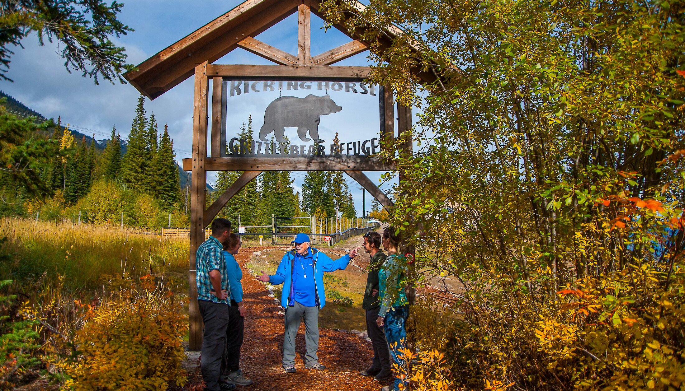 A guide talking to people outside the Grizzly Bear Refuge at Kicking Horse Mountain Resort