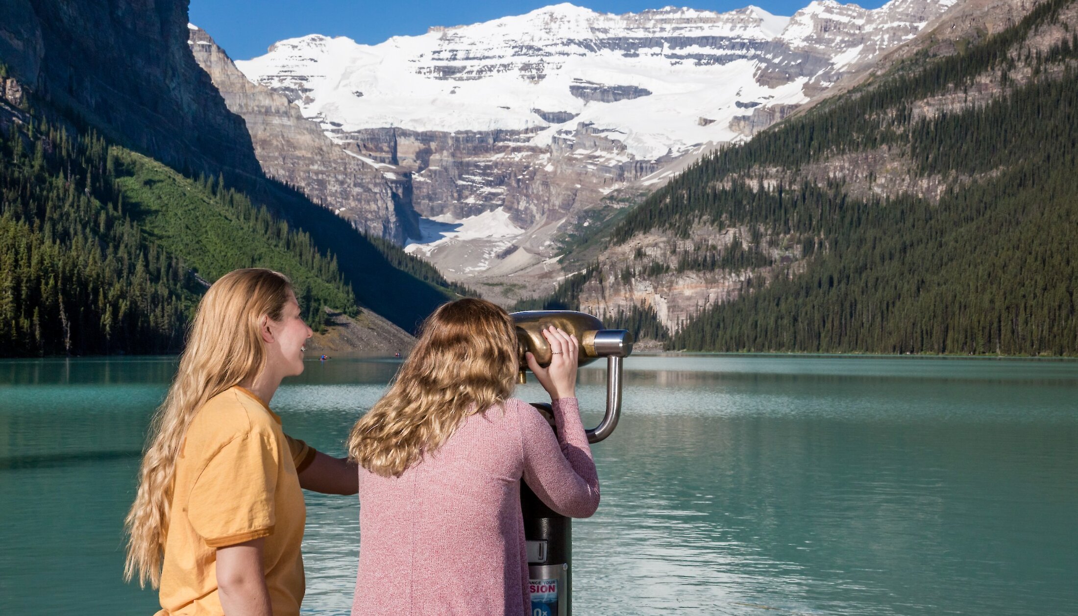 Friends overlooking Lake Louise through a view finder