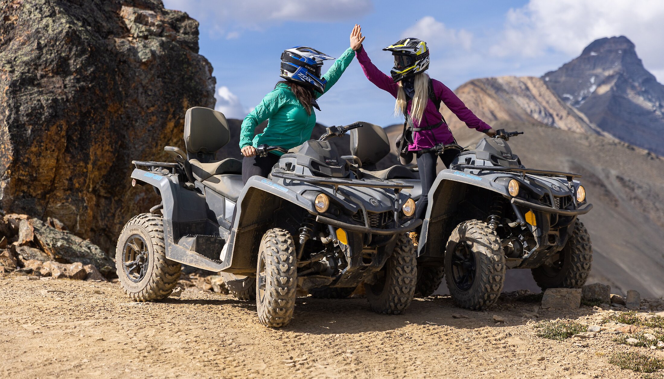 Guests high fiving on ATV trail