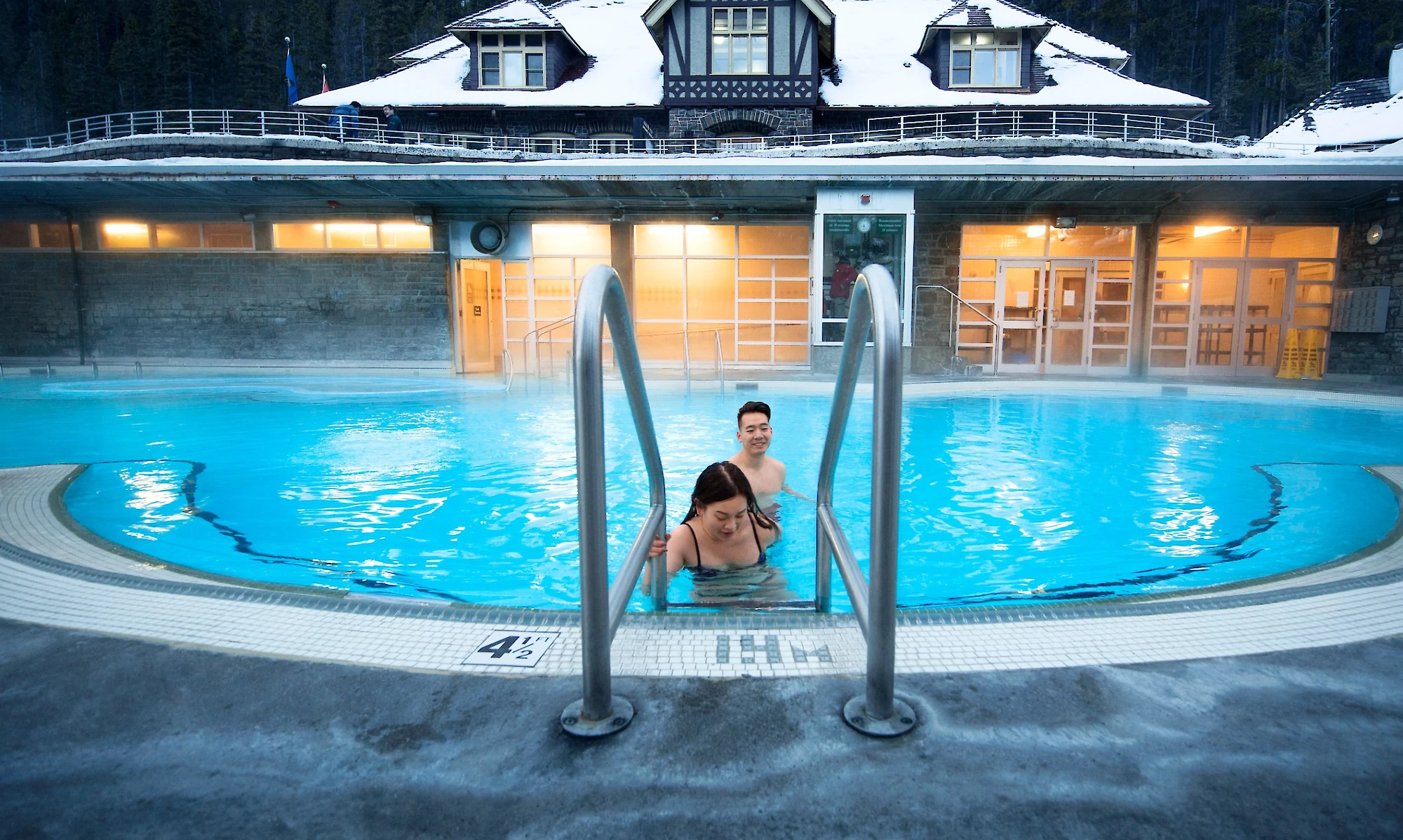 A couple soaking in the Banff Upper Hot springs