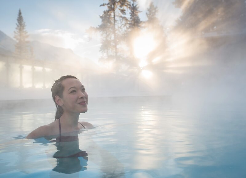 A lady in the Banff Upper Hot Springs enjoying the hot mineral water