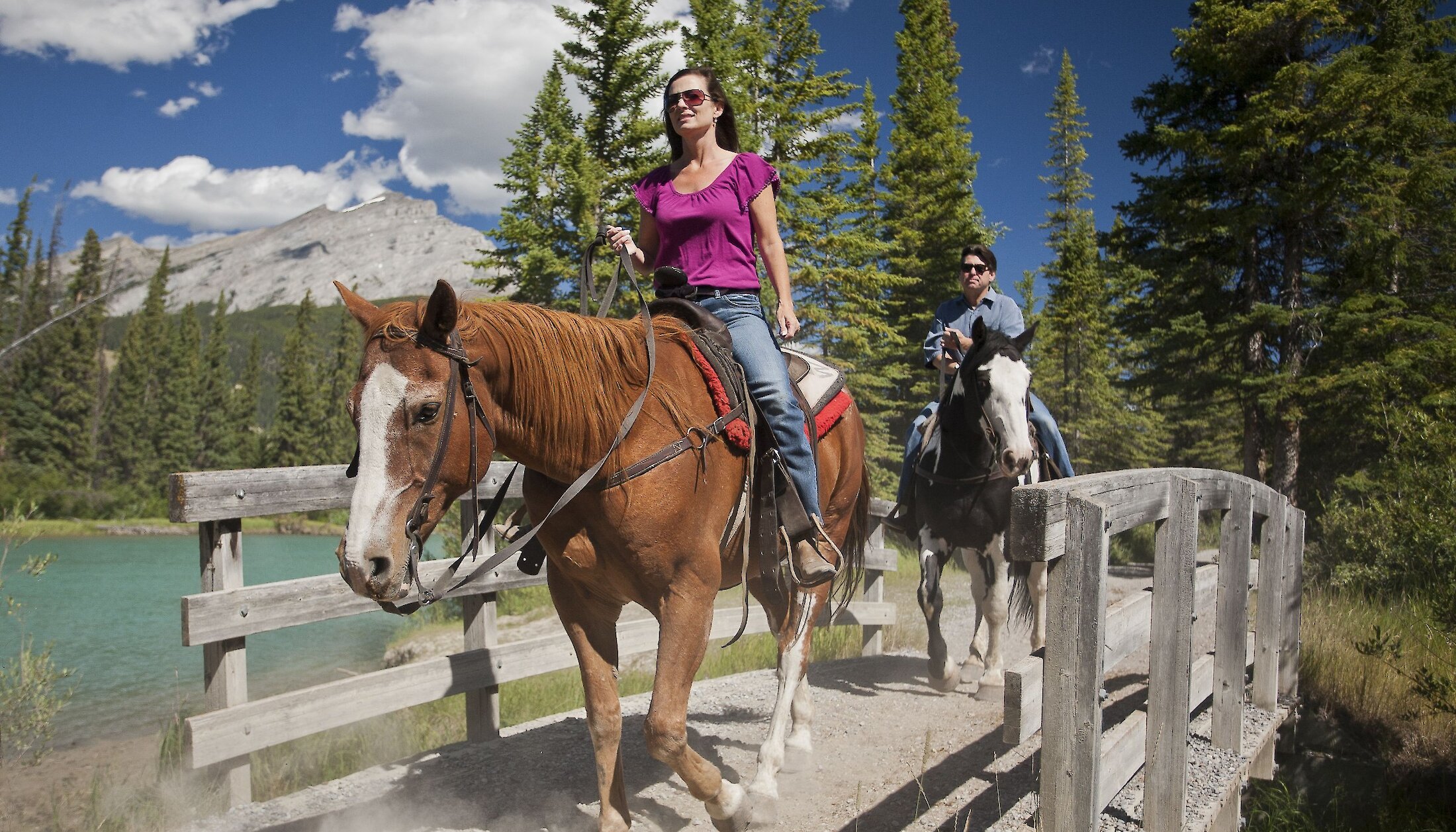Crossing a bridge during a horseback trail ride in Banff