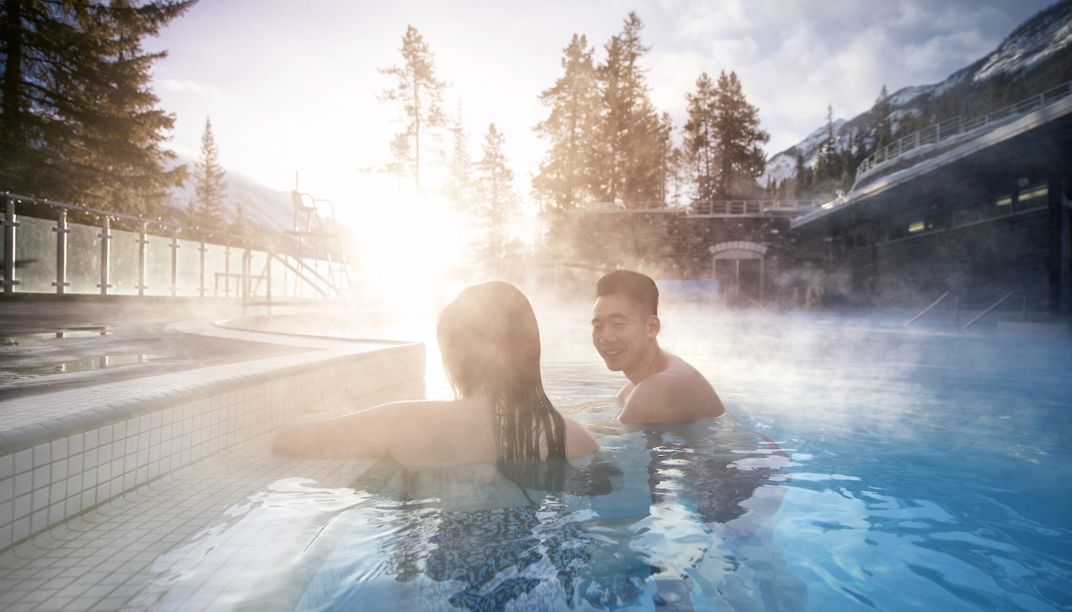 Couple enjoying a warm soak in the Banff Upper Hotsprings