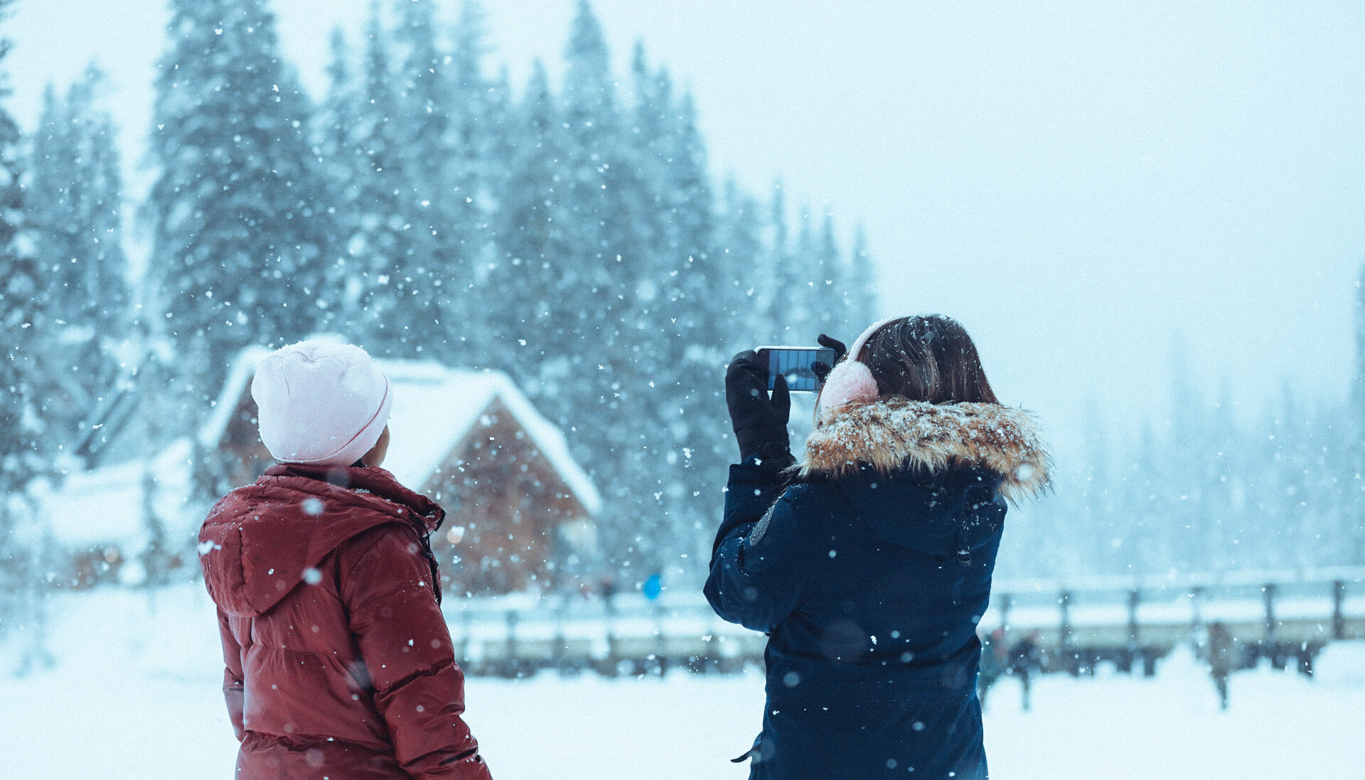 Friends taking photos of Emerald Lake in British Columbia