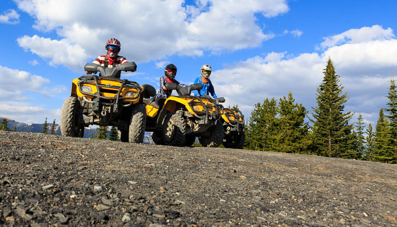 Two ATVs stationary on a trail in Golden on an offroad adventure