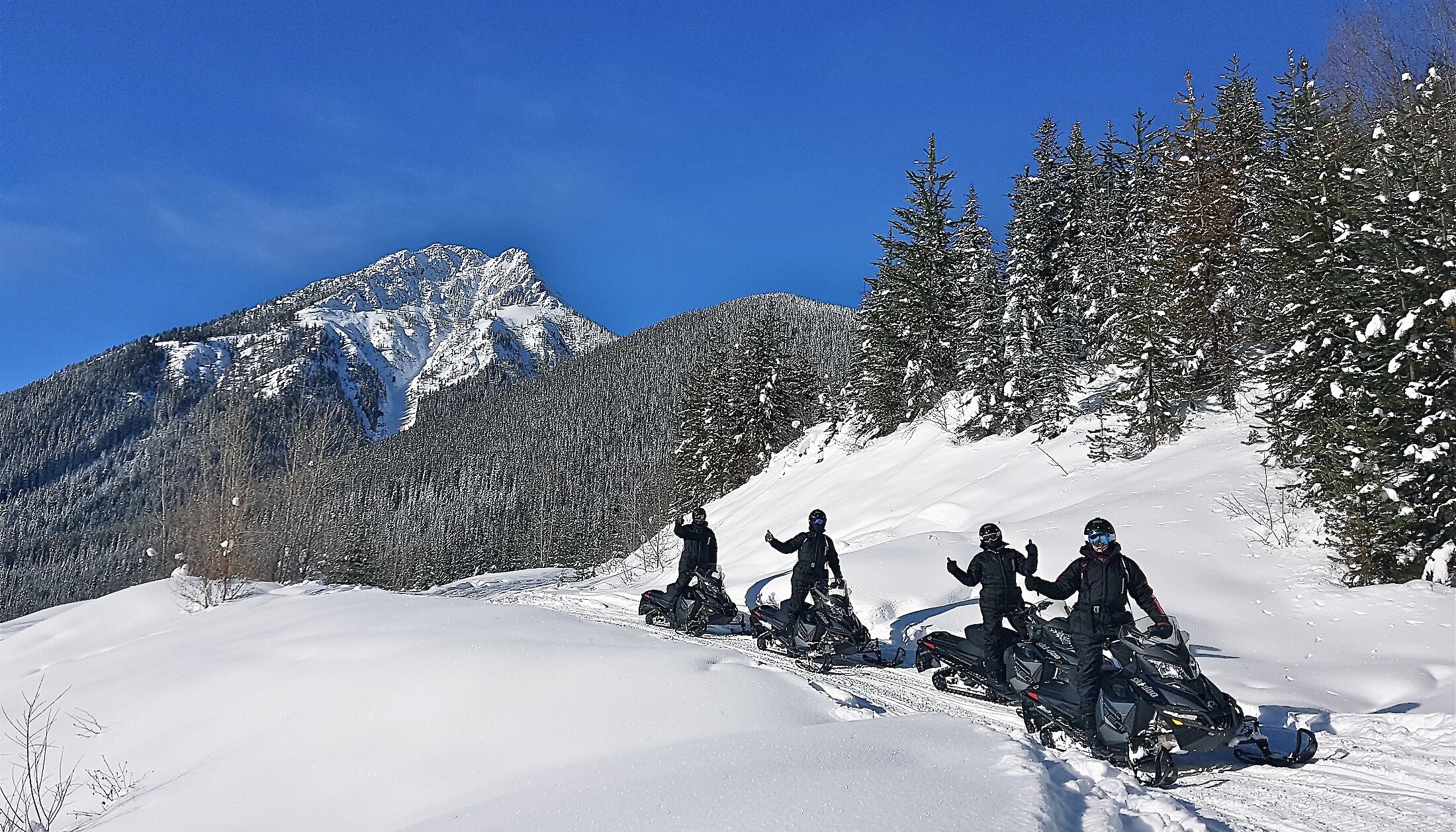 Snowmobilers admiring the stunning views on the Golden Snowmobile Tour