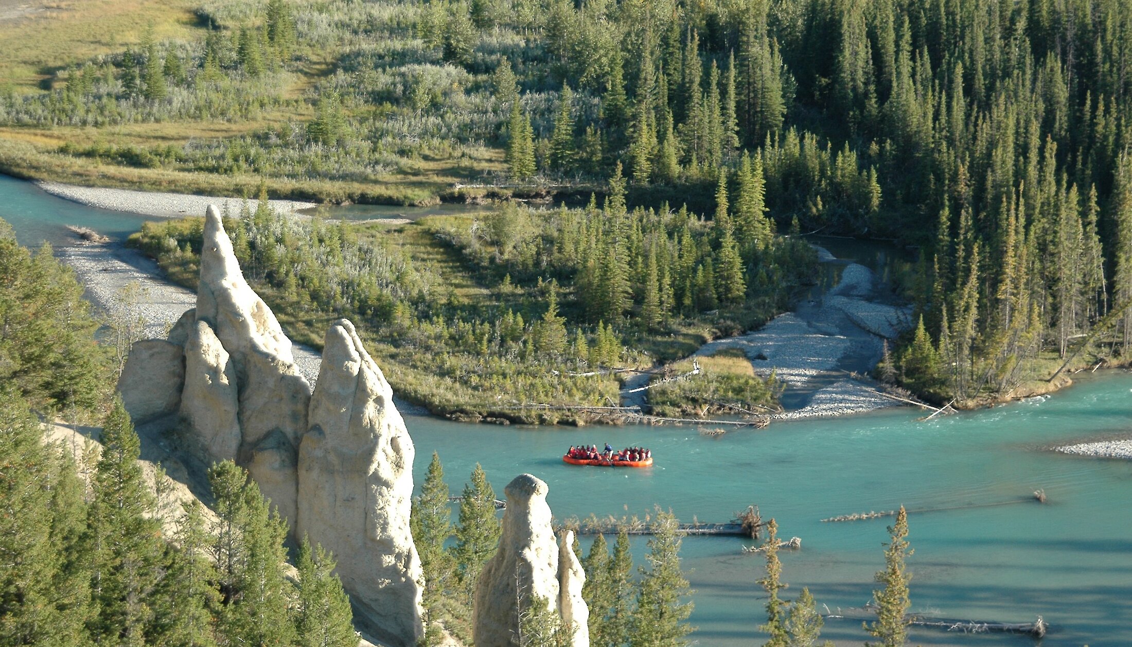 Aerial view of raft floating past the Hoodoos on the Bow River