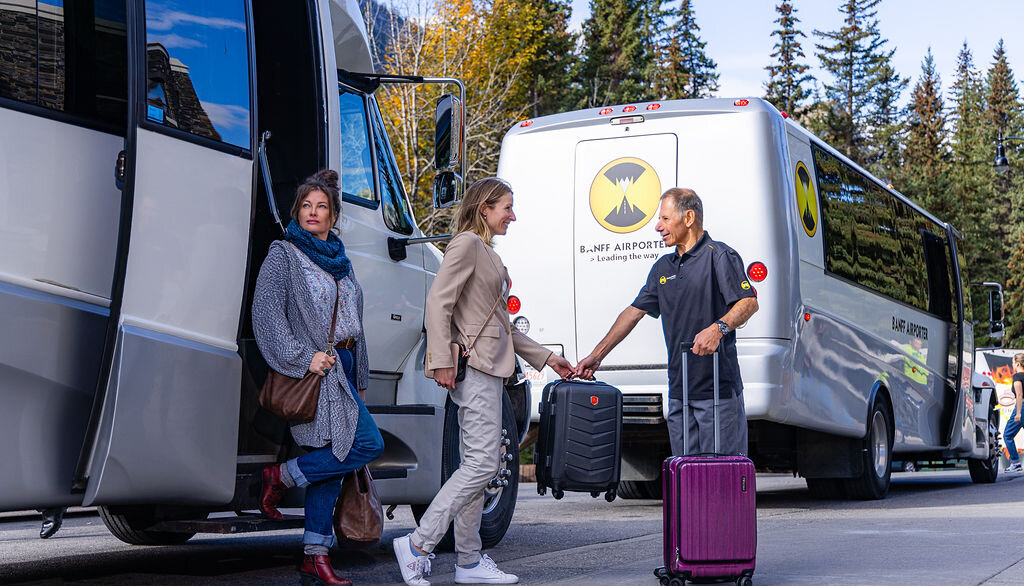 Friends arriving in Banff and the helpful driver assisting with bags