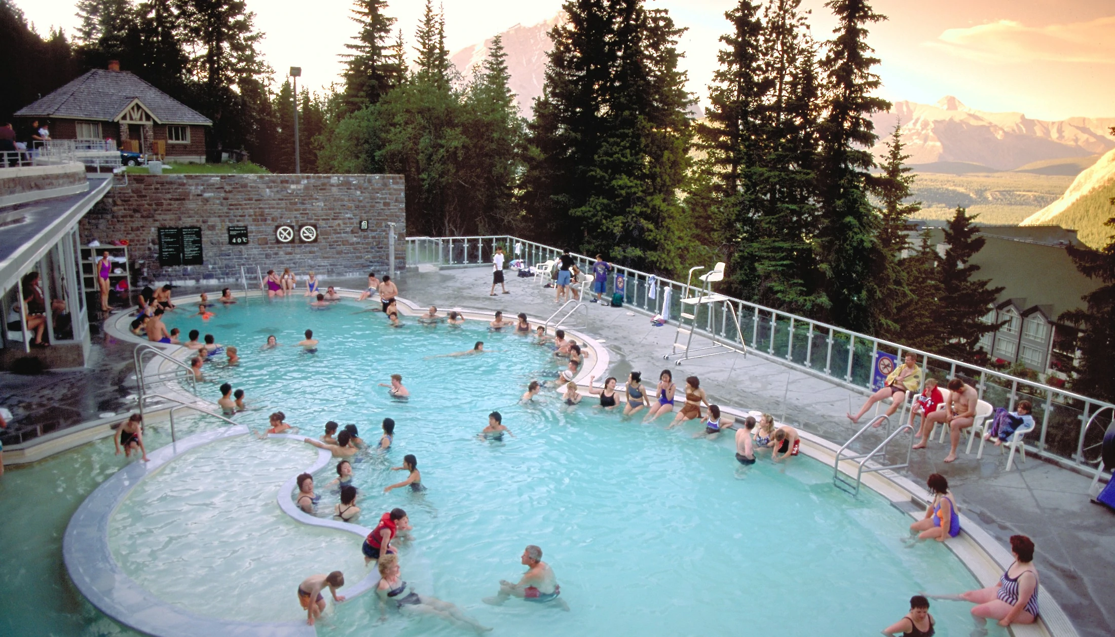 View crowd bathing in the hot mineral water at Banff Hot Springs