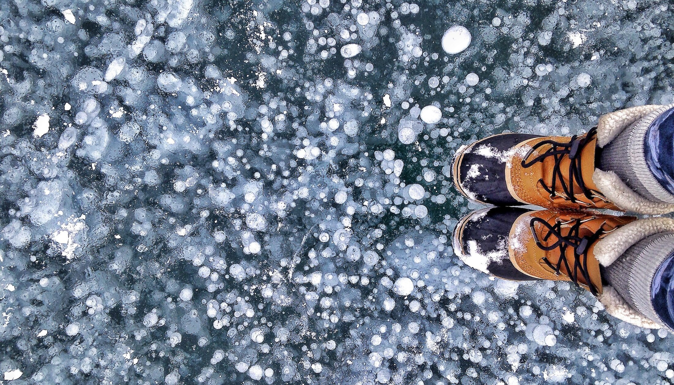 Looking down on the ice bubbles on a frozen Abraham lake