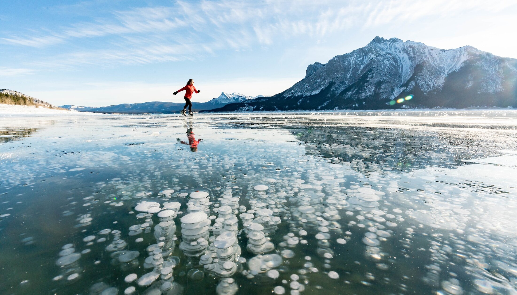 Ice skating over the ice bubbles on Abraham Lake in Alberta