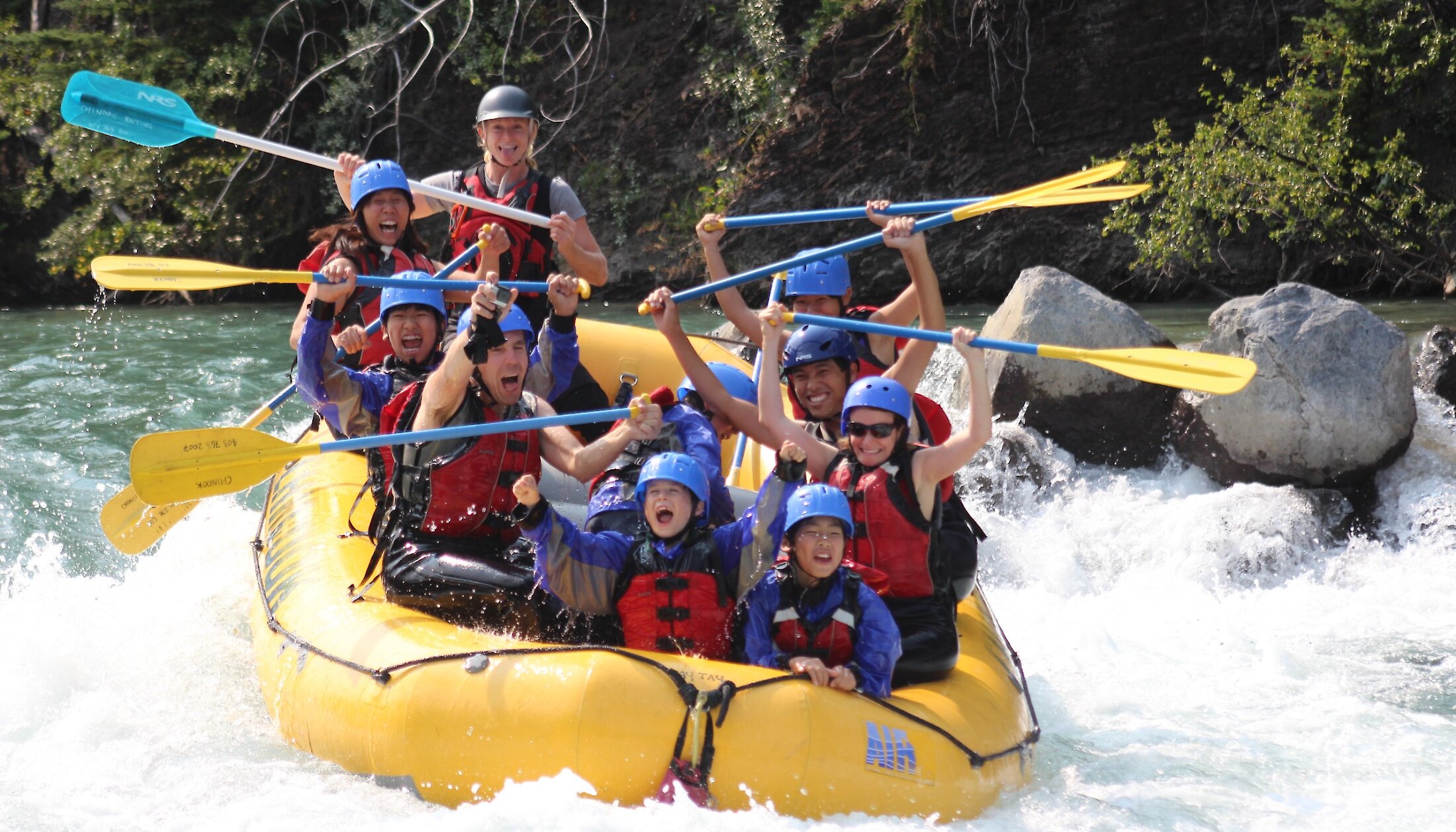 Everyone cheering whilst riding a class 3 rapid and getting splashed