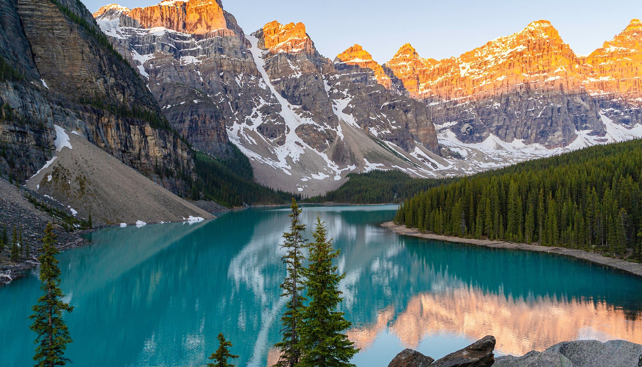 Sunrise at Moraine Lake when the mountains glow and turquoise water glitters