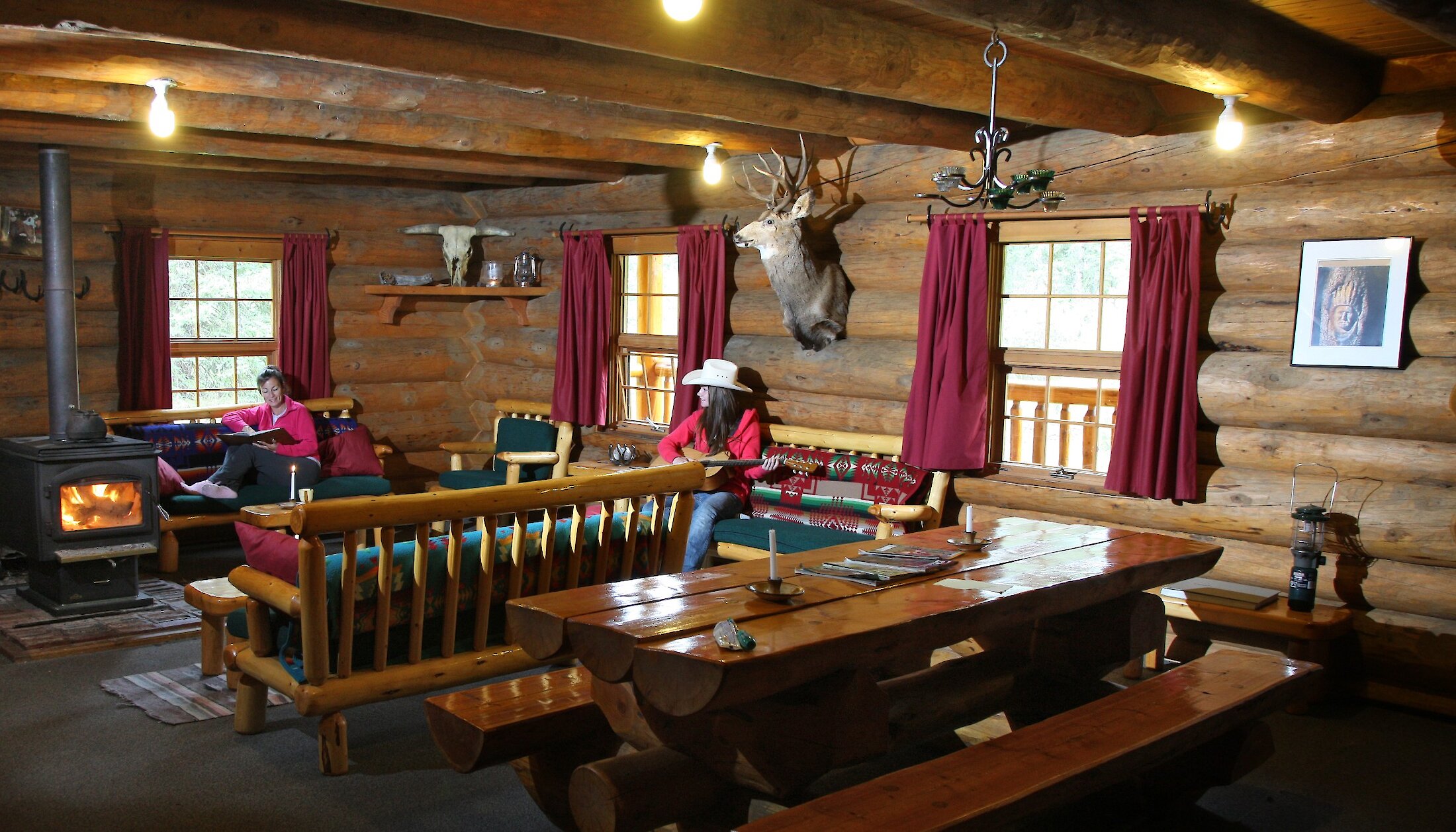 Guests relaxing in the lodge by the fire in Banff National park