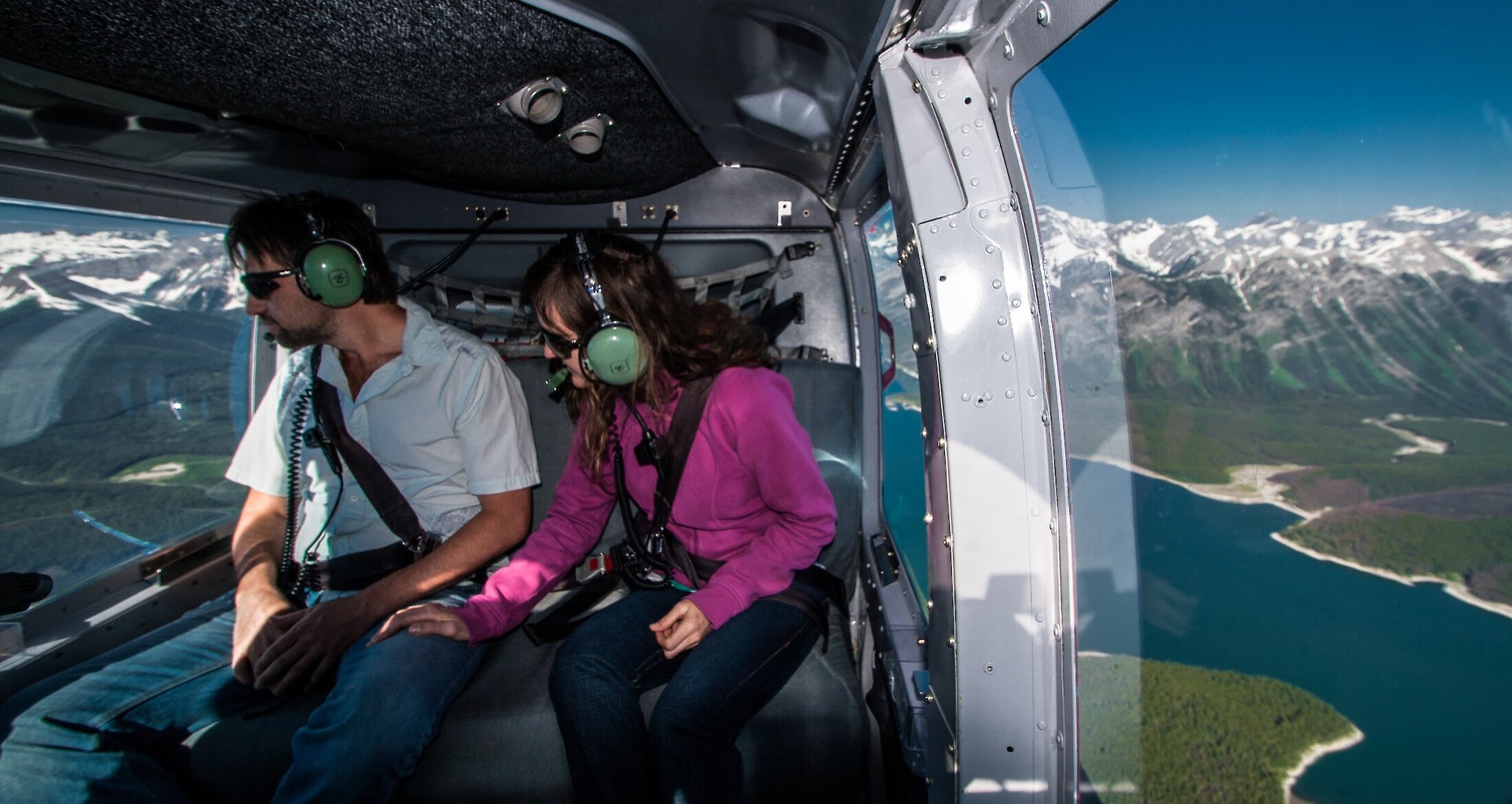 A couple enjoying a helicopter flight over Banff National Park