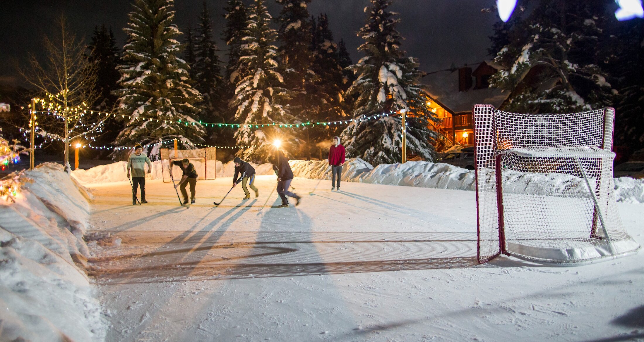 People playing hockey on an outdoor rink in Banff National Park