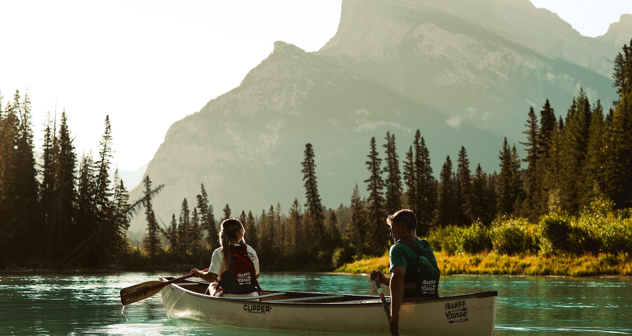 2 people paddling a canoe on the Bow River in Banff