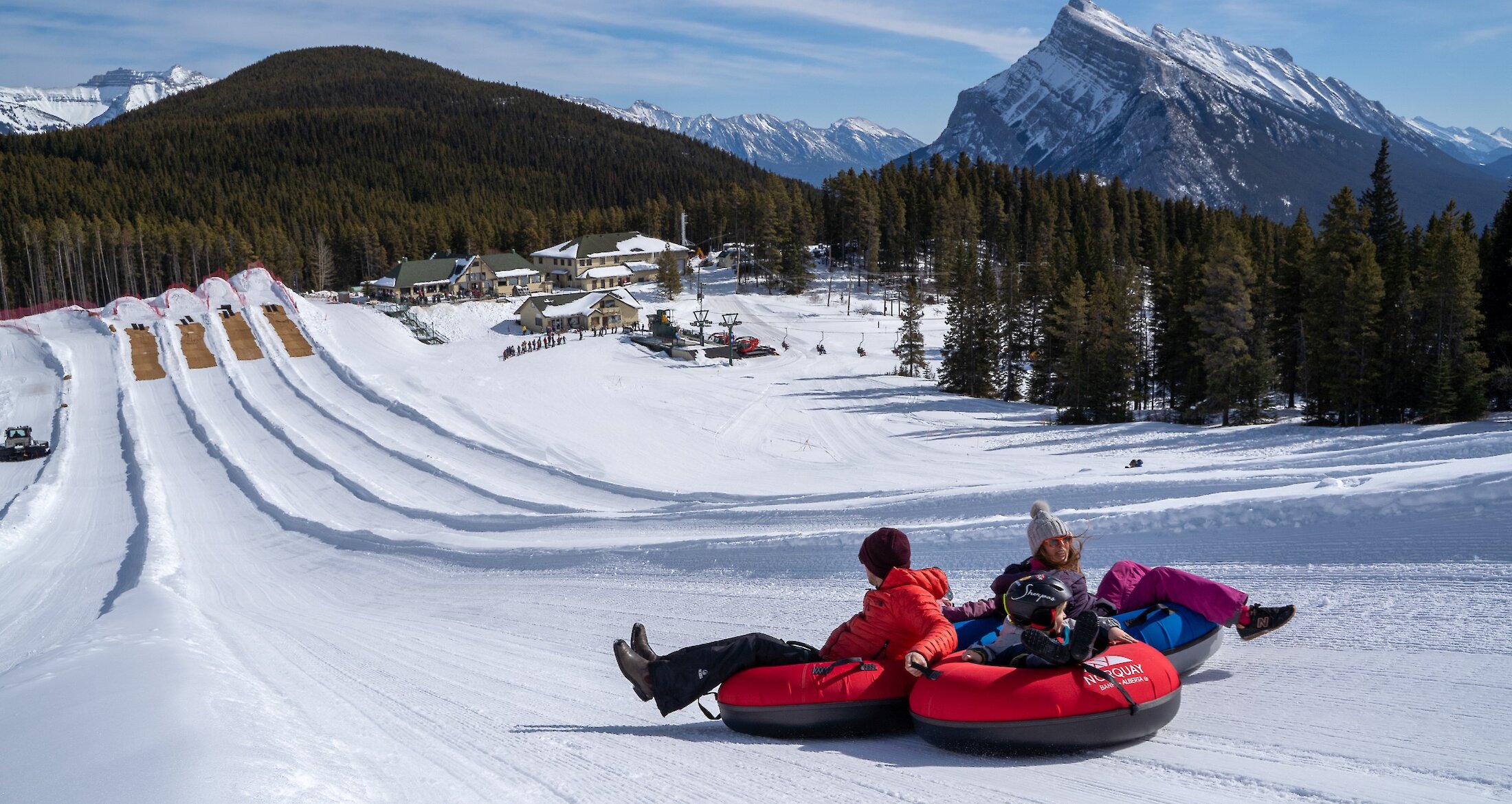 A group sliding down a tube lane at Mount Norquay in Banff