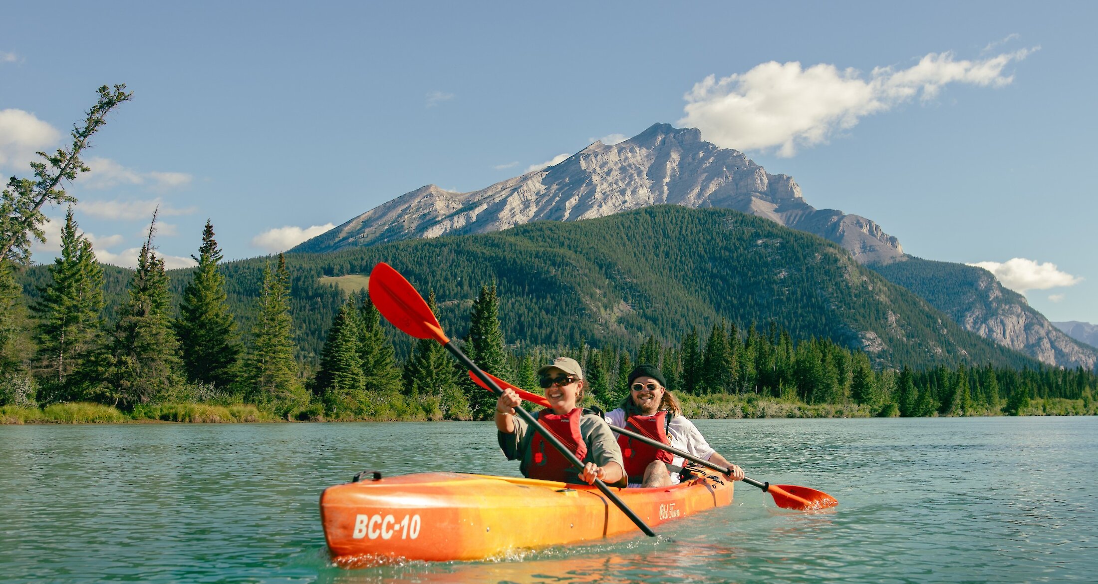 A couple of friends kayaking on the bow river in Banff